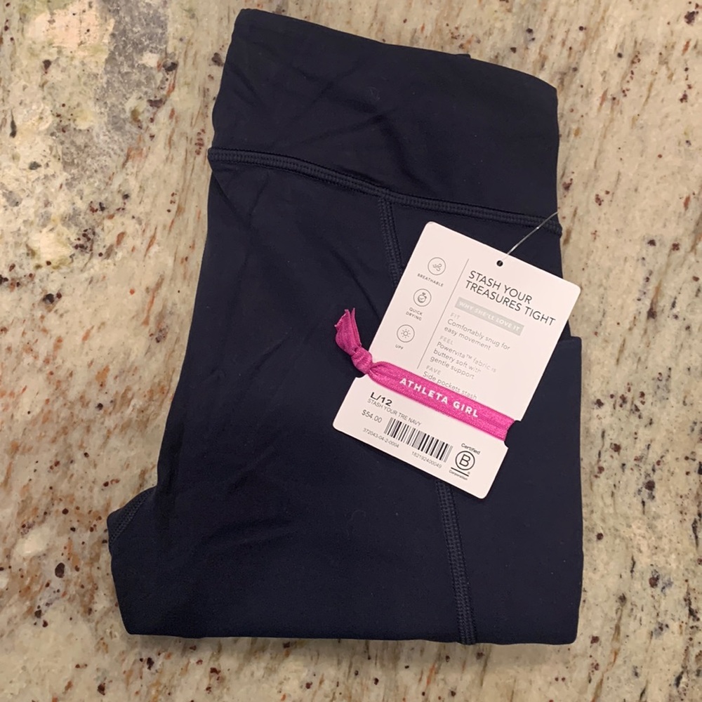 NWT:  Athleta girl “stash your treasures tight”. Size 12.  Navy.